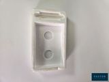 a white box with two holes in it on a table