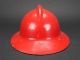 an image of a red fireman ' s helmet on a black background