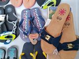 many pairs of flip flops laid out on a table