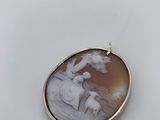 a close up of a pendant with a picture of a woman and child