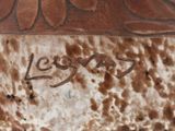 a close up of a brown vase with writing on it
