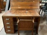 a wooden desk with a drawer underneath it in a room