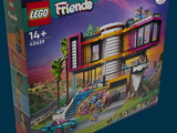 a box of lego friends set with a car in front of it