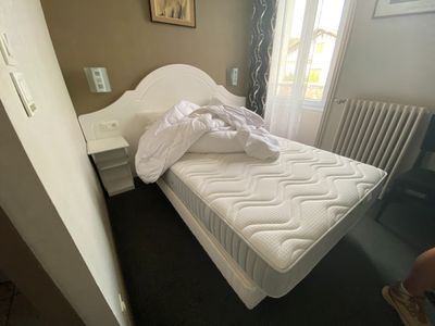a bed that has a mattress on it in a room
