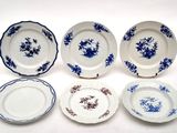 six blue and white plates with flowers on them on a white surface