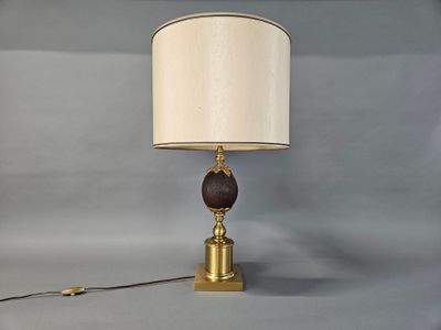 brass and wood table lamp with a white shade on a gray background