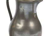 an old silver pitcher with a handle on a white background