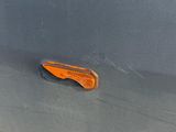 a close up of a car door handle with an orange light on it