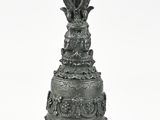 a large metal bell with a crown on top of it
