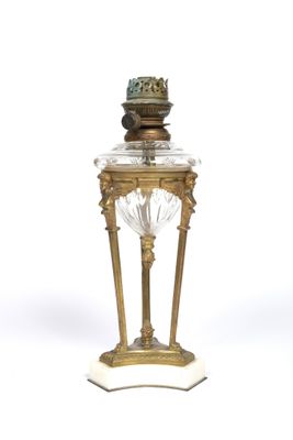 a gold and glass vase with a bird on top