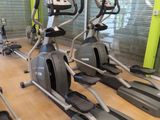 a row of stationary exercise bikes in a gym