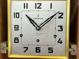 a clock that is sitting on a shelf in a room