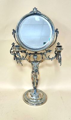 a mirror on a stand with a statue on it
