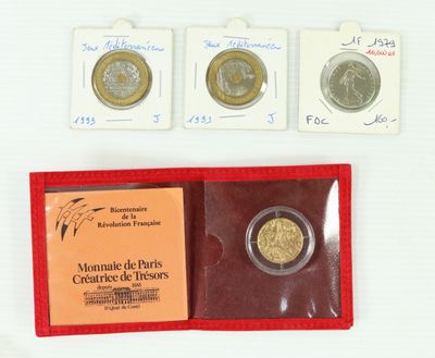 three coins are in a red case on a white surface