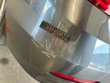 a sticker on the back of a silver car