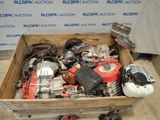 a wooden box filled with assorted motor and engine parts