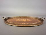a gold and brown tray with a floral design on it