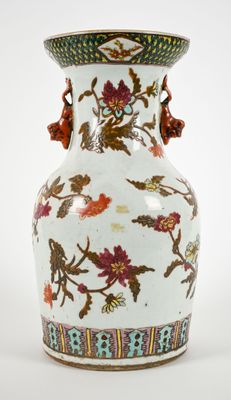 a white vase with a floral design on it