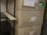 a large stack of boxes sitting on a shelf in a room