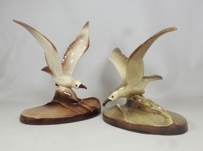 two figurines of birds that are sitting on top of each other