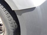 a close up of a car ' s tire on the side of the road