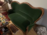 a green couch that is sitting in a room