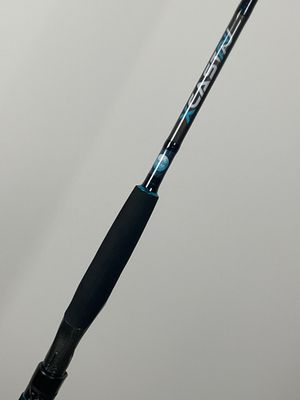 a close up of a black and blue fishing rod on a white surface
