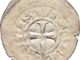 a close up of a coin with a cross on it