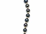 a close up of a black beaded necklace on a white background