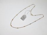 un collier muni d'une étiquette, posé sur une table