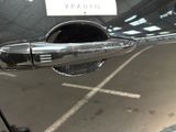 a close up of a car door handle with a sticker on it