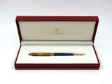 a close up of a pen in a red box on a white surface