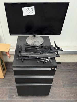 a tv on top of a black cabinet with guns on it