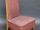 a pink chair with wooden legs and a pink upholstered seat
