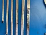 six wrenches and a clock on a blue surface