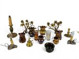 many different types of vases and candles on the table
