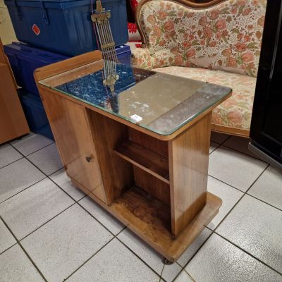 a glass table with a guitar on it in a living room