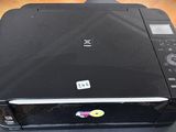 a black printer sitting on top of a wooden table
