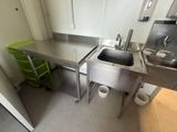 a kitchen with a sink and a trash can in it