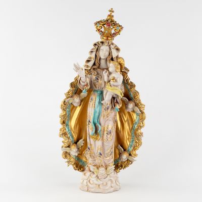 a statue of the virgin of guadalupe with a crown on her head