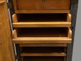 a wooden cabinet with drawers and a door open