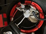 a red case with a fan and wires inside of it