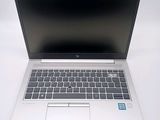 an open laptop computer sitting on top of a white table