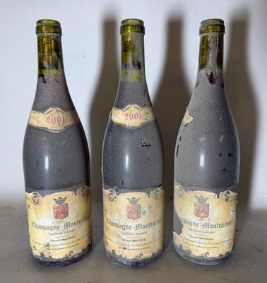 three bottles of wine sitting on a table with a white wall in the background