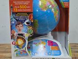 the globe is in the box on the table next to the box