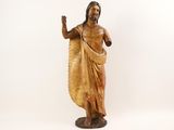 wooden statue of jesus with raised hand on a white background