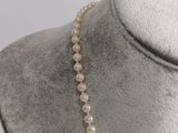 a close up of a necklace on a mannequin mannequin