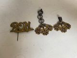 two pairs of gold earrings with a bird on top of them