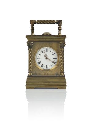 a gold clock with roman numerals on it