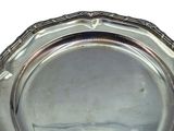 a silver plate on a table with a white background